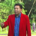 Descubre qué plantar en julio en Asturias para un jardín espectacular con una persona de chaqueta roja en un paisaje verde y luminoso